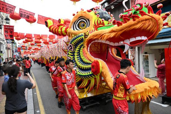 2月1日，由馬來西亞和中國的100多名青少年組成的舞龍隊在馬來西亞馬六甲市雞場街上共舞一條近200米的“長龍”。這是活動現(xiàn)場的“長龍”。新華社記者程一恒攝