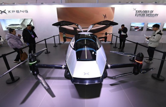 2023年12月1日，在鏈博會智能汽車鏈展區(qū)小鵬汽車展臺，參觀者觀看一臺智能飛行器。新華社記者蔡湘鑫攝