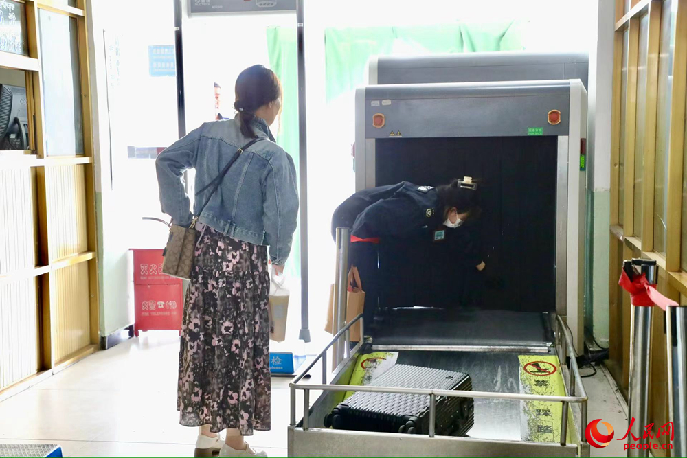 車站工作人員幫旅客提取行李。人民網(wǎng)記者 次仁羅布攝